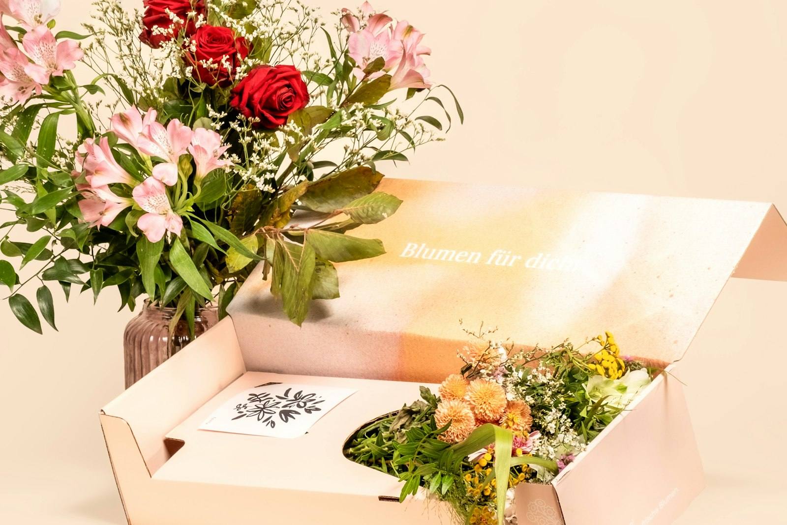 Bouquet of flowers next to an open gift box
